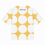 T-shirt with yellow and white polka dot pattern on a white background