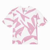 A white short-sleeve t-shirt with an abstract pink brushstroke pattern, featuring the brand name 'clutter pop' printed in black near the inner collar.