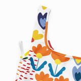Colorful children's apron with floral and heart patterns on a white background