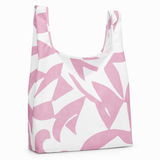 A reusable tote bag with a bold pink and white abstract floral pattern, shown on a clean white background.