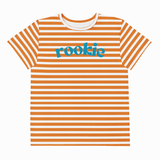 A short-sleeve crewneck t-shirt with horizontal orange and white stripes, featuring the word 'rookie' printed across the chest in a teal blue script font, shown against a plain white background.