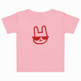 Pink t-shirt with a red graphic of a face wearing sunglasses on a white background