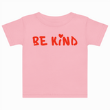 Pink t-shirt with 'BE KIND' text on a white background