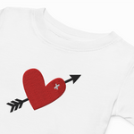 White shirt with a red heart and black arrow design on a white background