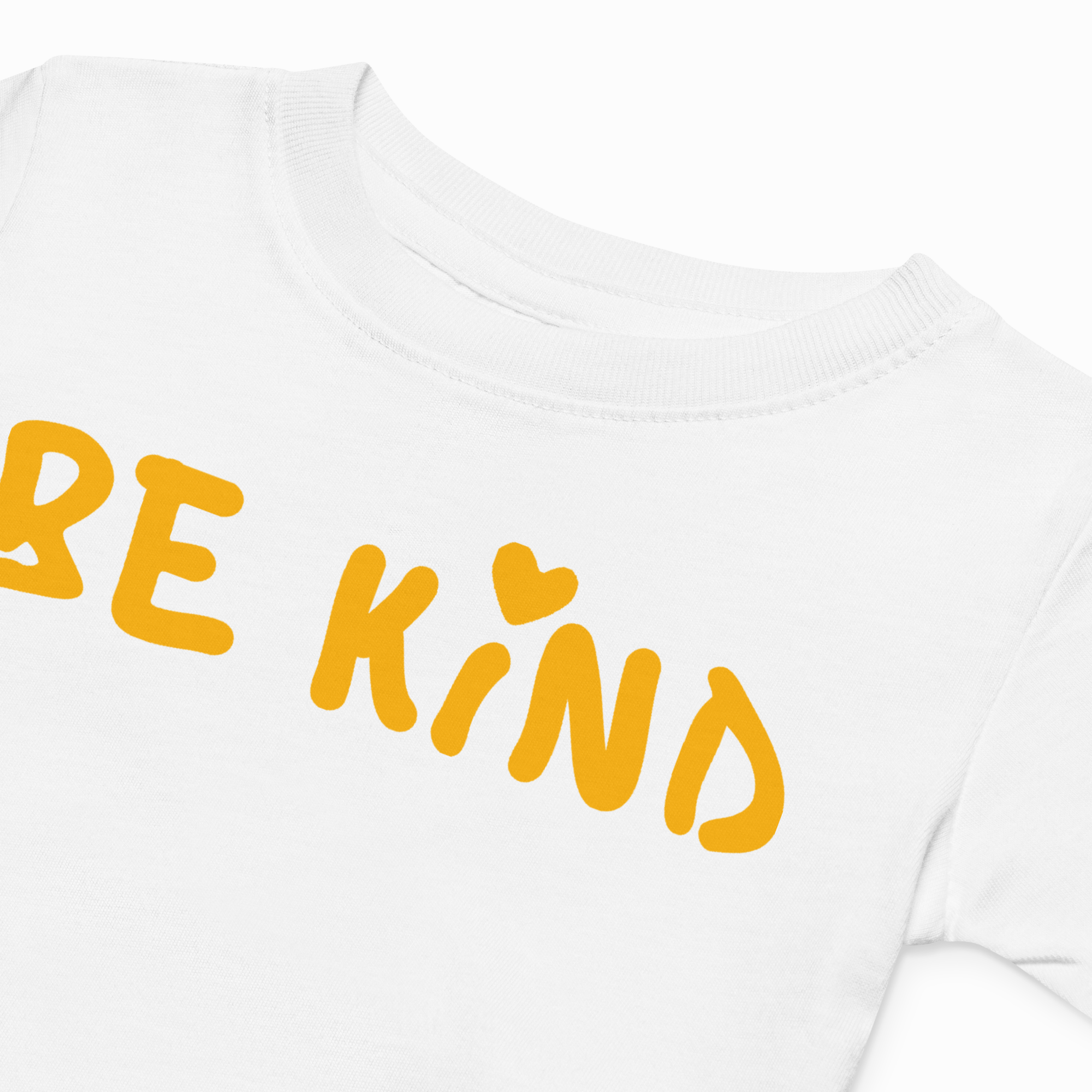 White shirt with 'BE KIND' text in yellow on a white background