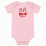 Pink baby onesie with a red graphic of a rabbit wearing sunglasses on a white background