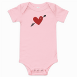 Pink baby onesie with a red heart and black arrow design on a white background