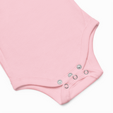 Close-up of a pink baby onesie with button details on a white background