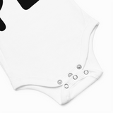 Close-up of a white bodysuit with button details on a light gray background