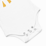 White baby romper with button details on a light gray background