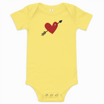Yellow baby onesie with a red heart and black arrow design on a white background