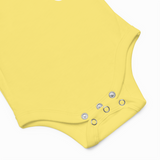 Yellow baby romper with button details on a white background