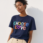 Person wearing a navy blue t-shirt with 'CHOOSE LOVE' text in colorful letters against a white background