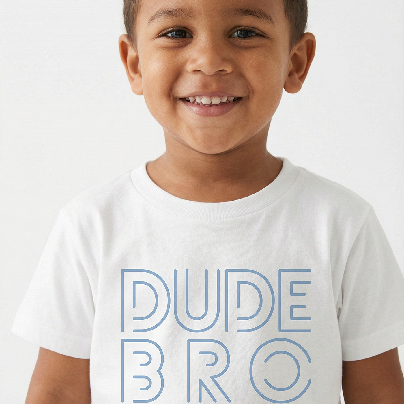 Child wearing a white t-shirt with 'DUDE BRO' text on a plain background