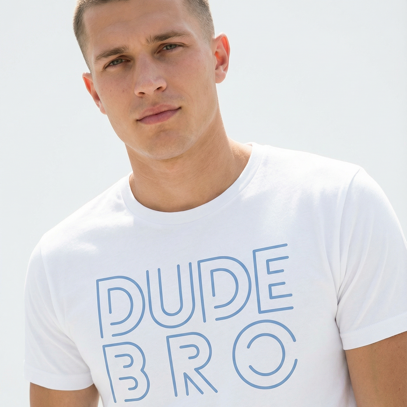 Man wearing a white t-shirt with 'DUDE BRO' text on a light background