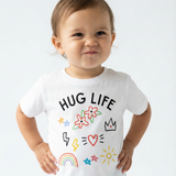 Child wearing a white t-shirt with 'HUG LIFE' and colorful graphics on a light gray background