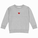 Gray sweatshirt with 'TOGA' printed on it against a white background