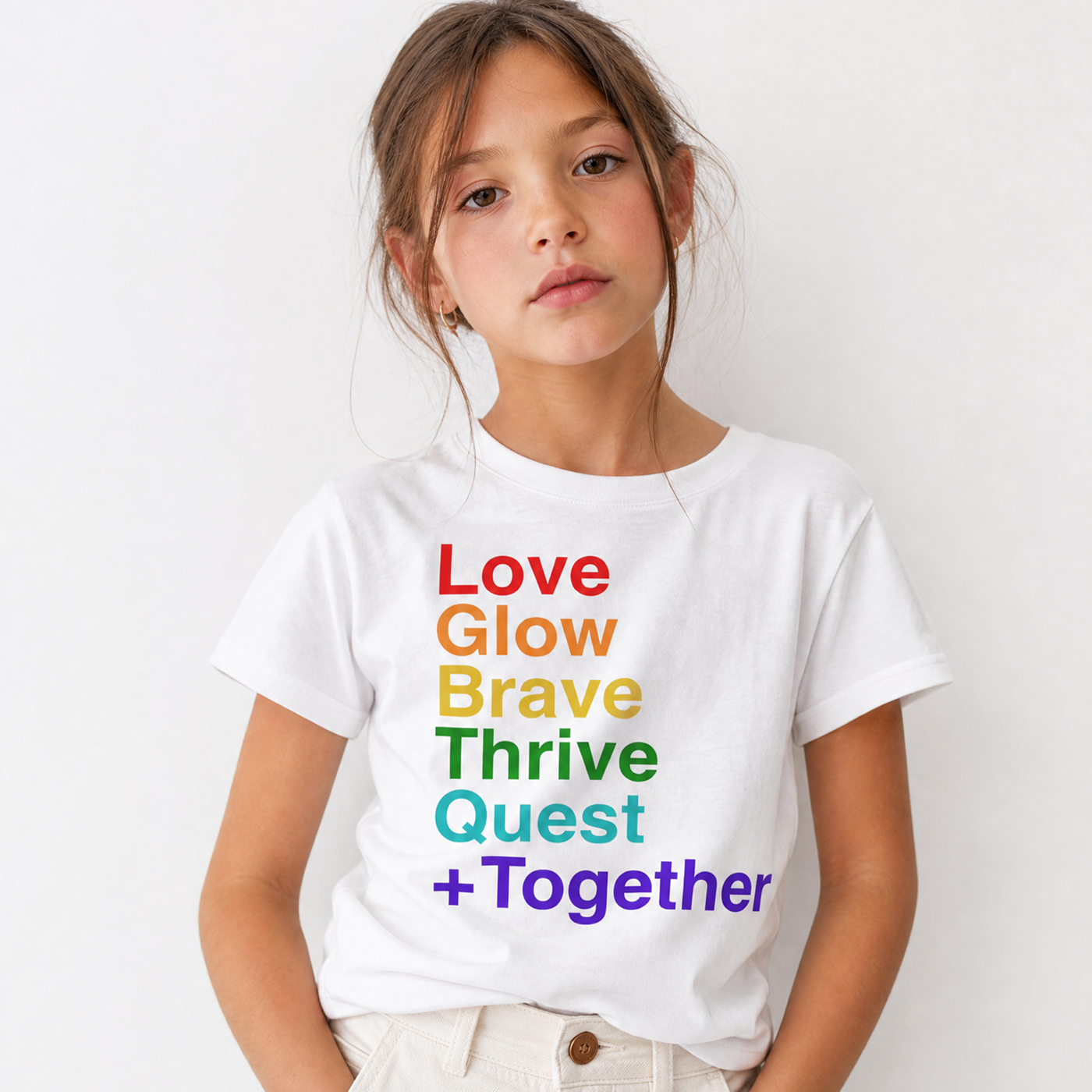 Child wearing a white t-shirt with motivational phrases in colorful letters on a plain background