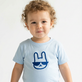Child wearing a light blue t-shirt with a blue graphic on a white background