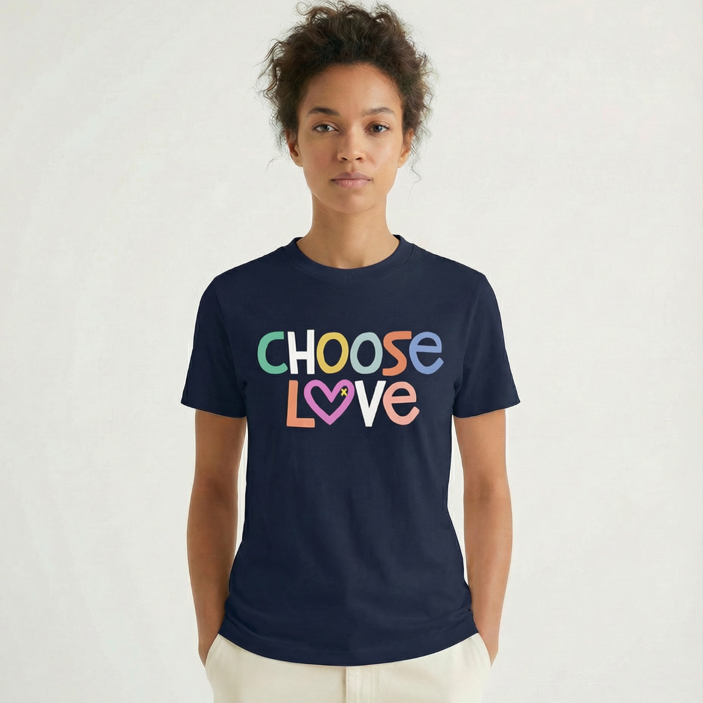 Person wearing a navy blue t-shirt with 'CHOOSE LOVE' text in colorful letters on a white background