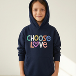 Child wearing a navy hoodie with 'CHOOSE LOVE' in colorful letters on a light background
