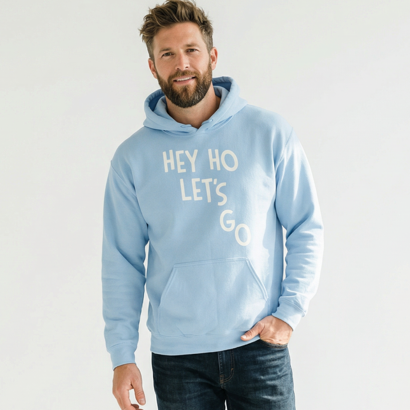 Man wearing a light blue hoodie with 'HEY HO LET'S GO' text on a white background
