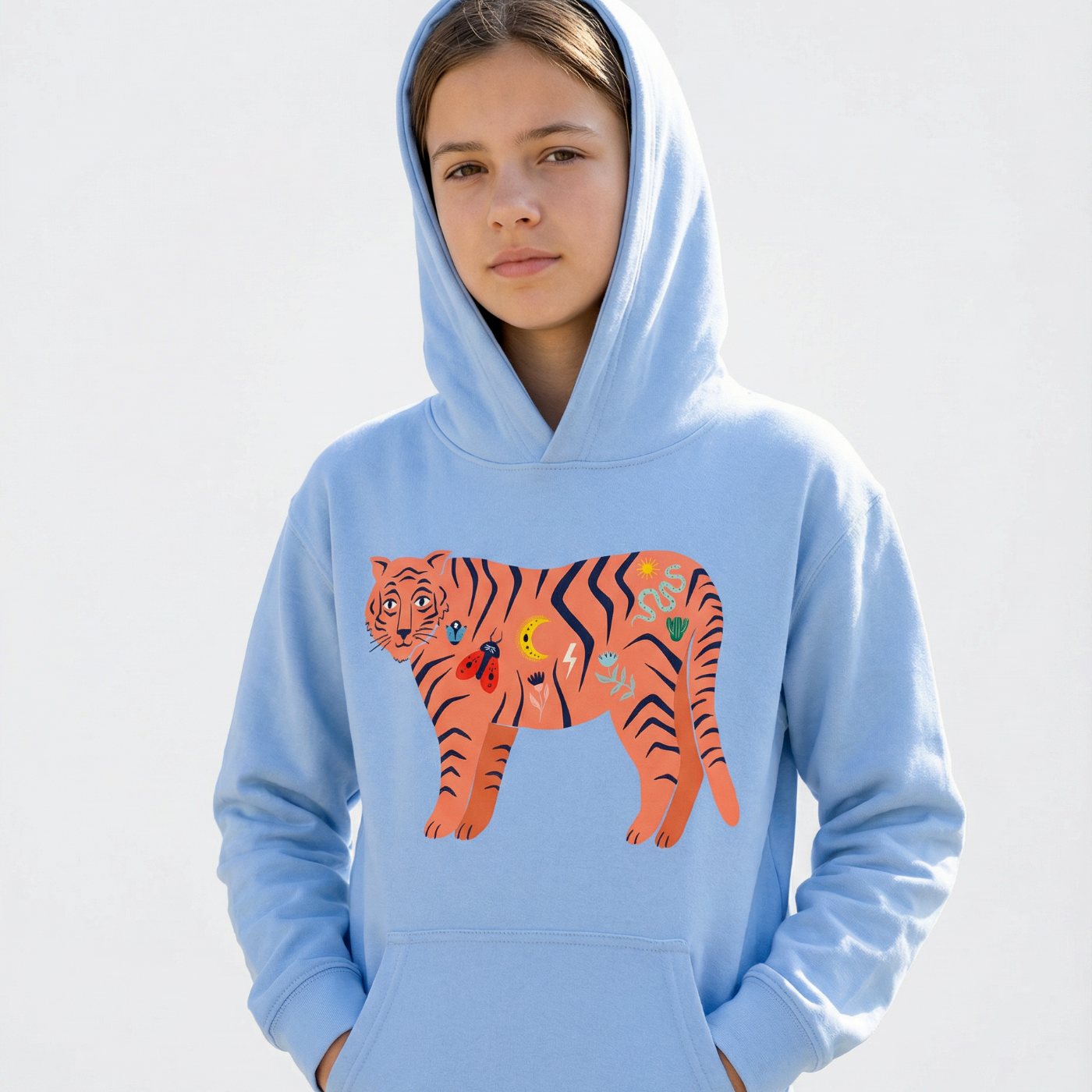 Person wearing a light blue hoodie with a tiger design on a white background
