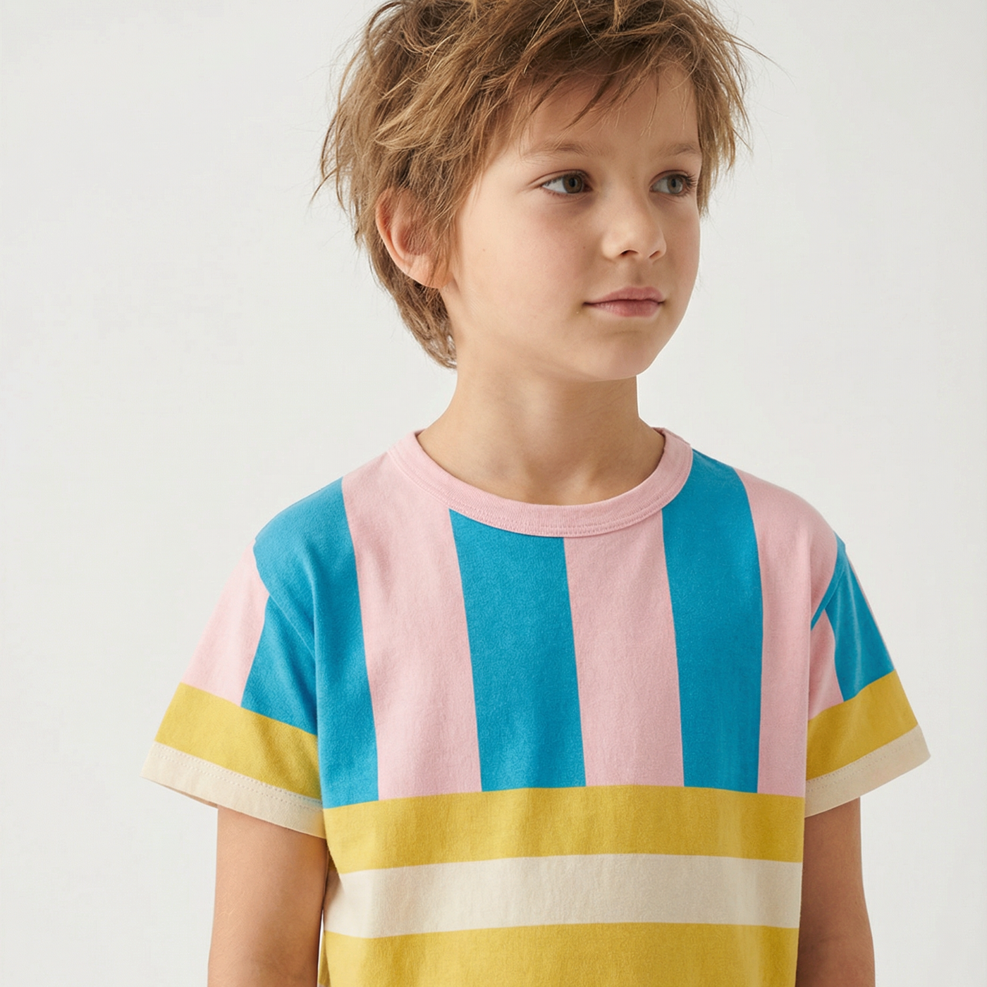 Child wearing a colorful striped shirt on a white background