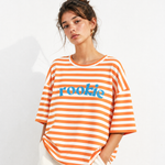 Woman wearing an orange and white striped shirt with 'rookie' text on a white background
