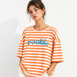 Woman wearing an orange and white striped shirt with 'rookie' text on a white background