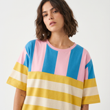 Woman wearing a colorful striped shirt on a white background