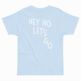 Light blue t-shirt with 'HEY HO LET'S GO' text on a white background