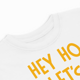 White t-shirt with yellow text 'HEY HO LET'S GO' on a white background