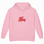 A light pink children's pullover hoodie with the words 'NOT SORRY' printed in red across the chest, shown against a plain white background.