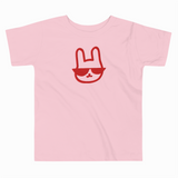 Pink t-shirt with a red graphic of a face wearing sunglasses on a white background