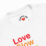 White t-shirt with colorful text and a heart logo on a white background