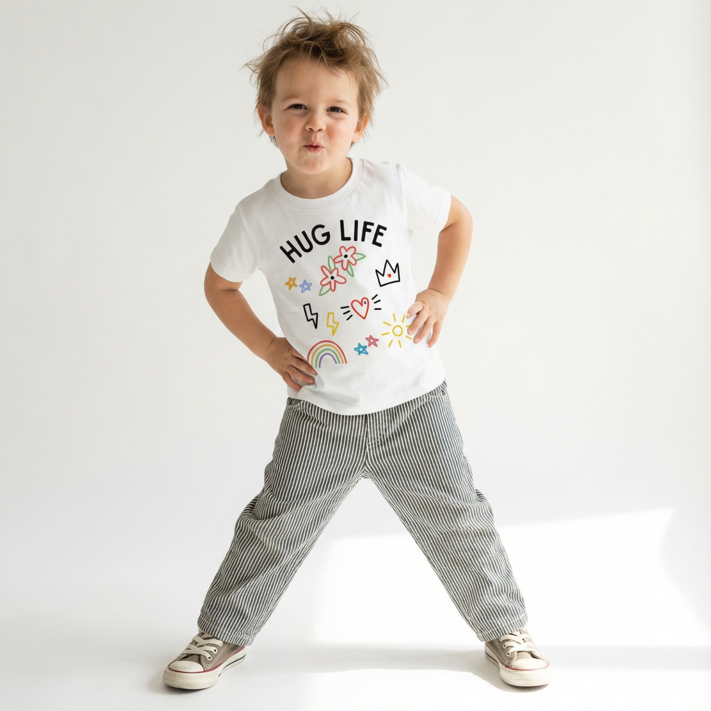 Child wearing a white t-shirt with 'Hug Life' text and graphics on a plain background