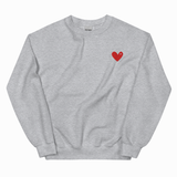 A light heather gray crewneck sweatshirt with a small red heart embroidered on the left chest, displayed flat against a white background.