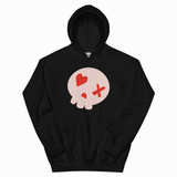 A black pullover hoodie with a graphic of a pale pink skull on the chest, featuring a red heart and a red cross for eyes.