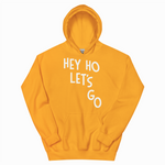 Yellow hoodie with 'HEY HO LET'S GO' text on a white background