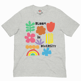 Athletic heather gray unisex staple T-shirt with colorful "Bloom in Diversity" graphic featuring flowers, a leaf, a rainbow, and abstract shapes; Chatter Pop label at collar.