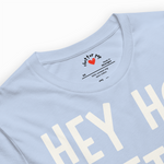 Light blue t-shirt with 'HEY' printed on it, featuring a brand logo.