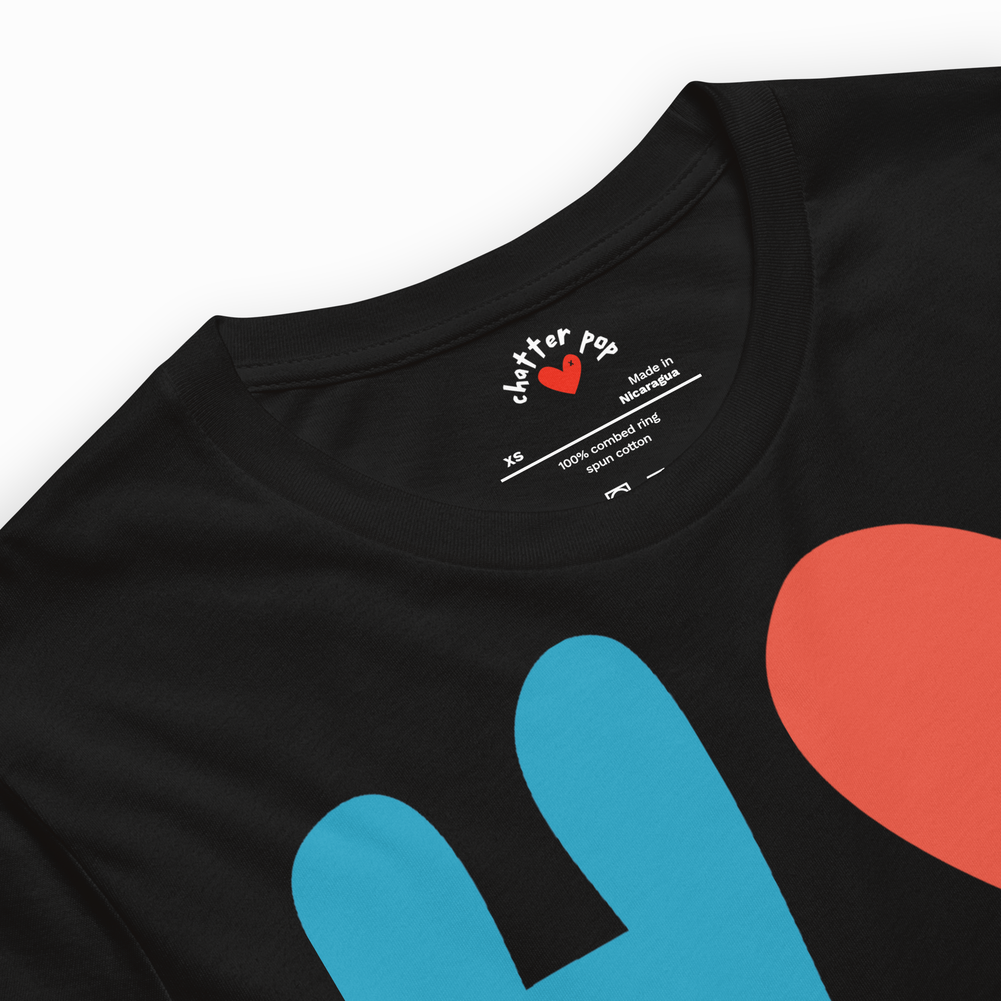 Black t-shirt with colorful heart designs and 'chatter pop' branding on a white background
