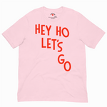 Pink t-shirt with red text 'HEY HO LET'S GO' on a white background