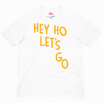 White t-shirt with yellow text 'HEY HO LET'S GO' on a white background