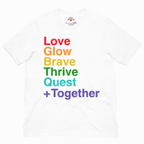 A white short-sleeve crewneck t-shirt featuring a stacked rainbow text graphic on the front that reads 'Love Glow Brave Thrive Quest + Together'.