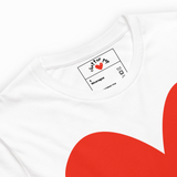 White t-shirt with a red heart design and a label on the collar.