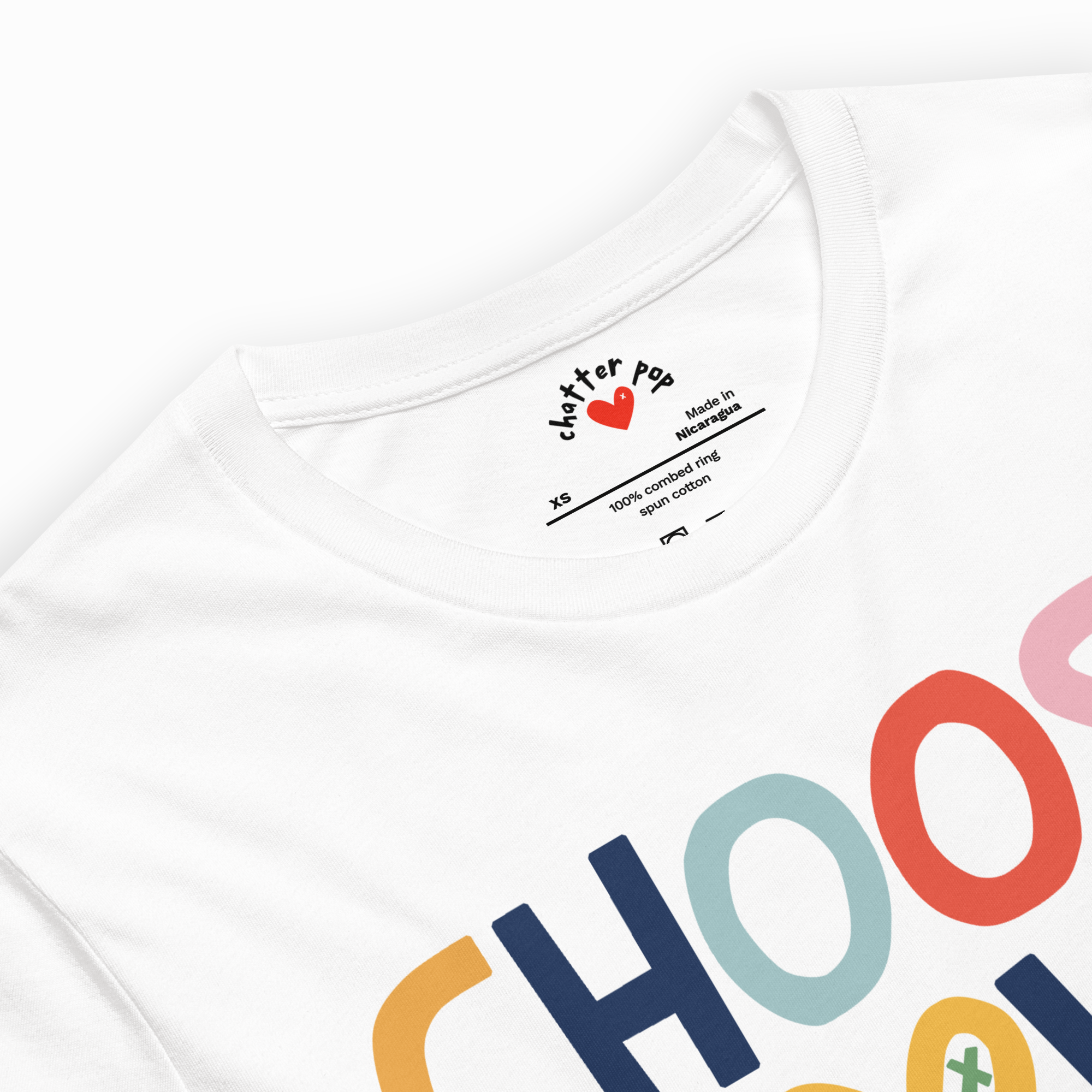 White t-shirt with colorful text and 'Chatter Pop' branding on a white background