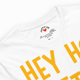 White t-shirt with yellow text and a visible brand logo on a white background