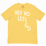 Yellow t-shirt with 'HEY HO LET'S GO' text on a white background